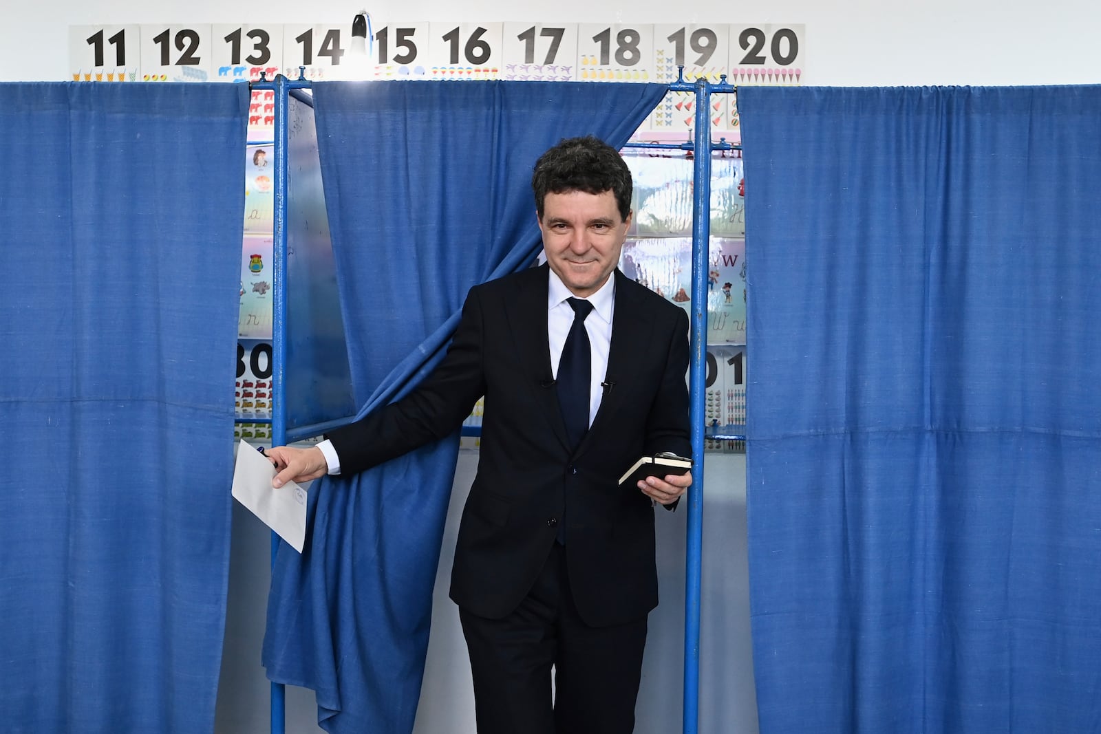 Presidential candidate Nicusor Dan exits a voting cabin before casting his vote in the second round of the country's presidential election redo in Fagaras, Romania, Sunday, May 18, 2025. (AP Photo/Eduard Vinatoru)