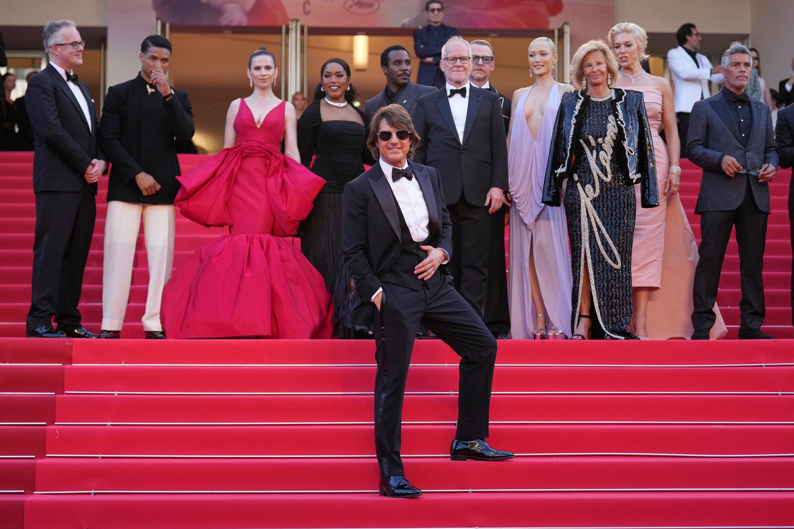 Tom Cruise, front, editor Eddie Hamilton, from back left, Greg Tarzan Davis, Hayley Atwell, Angela Bassett, Tramell Tillman, festival director Thierry Fremaux, Simon Pegg, Pom Klementieff, Iris Knobloch, Hannah Waddingham and Esai Morales pose for photographers upon arrival at the premiere of the film 'Mission: Impossible - The Final Reckoning' at the 78th international film festival, Cannes, southern France, Wednesday, May 14, 2025. (AP Photo/Natacha Pisarenko)