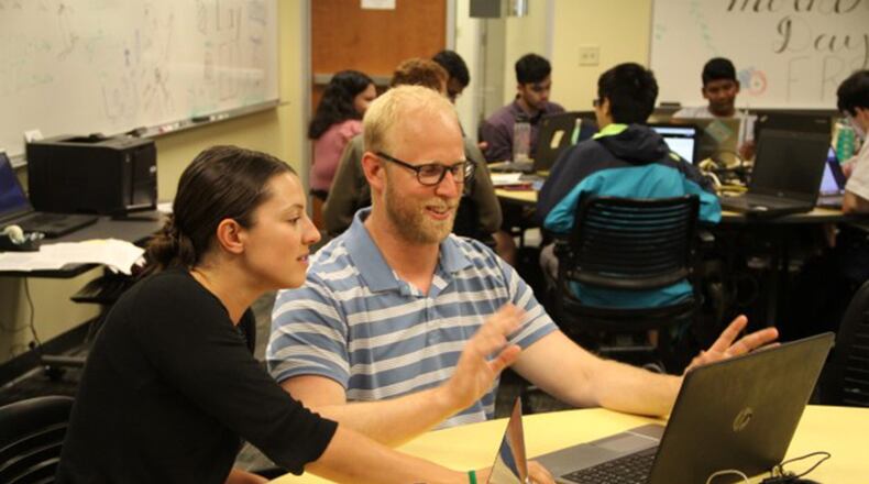 Air Force Research Laboratory researchers Dr. Theresa Scarnati and Dr. Chris Paulson collaborate at a Wright State University workplace for summer interns with the Autonomous Technology Research Center. (Courtesy photo)