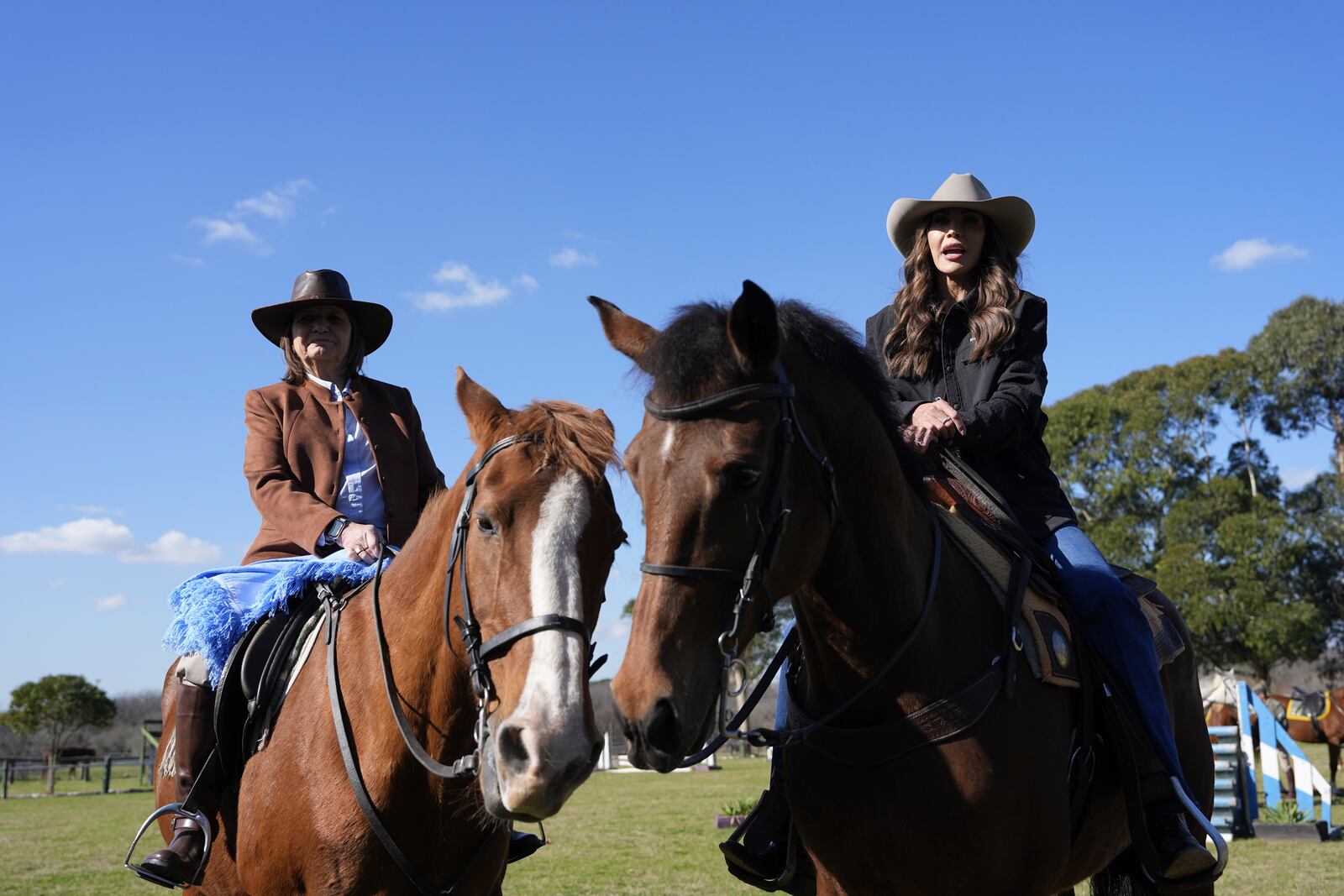 U.S. Homeland Security Secretary Kristi Noem, right, and Argentine National Security Minister Patricia Bullrich sit on horses as they speak to the press upon arrival to the Campo De Mayo Military Base in Buenos Aires province, Argentina, Monday, July 28, 2025. (AP Photo/Alex Brandon, Pool)