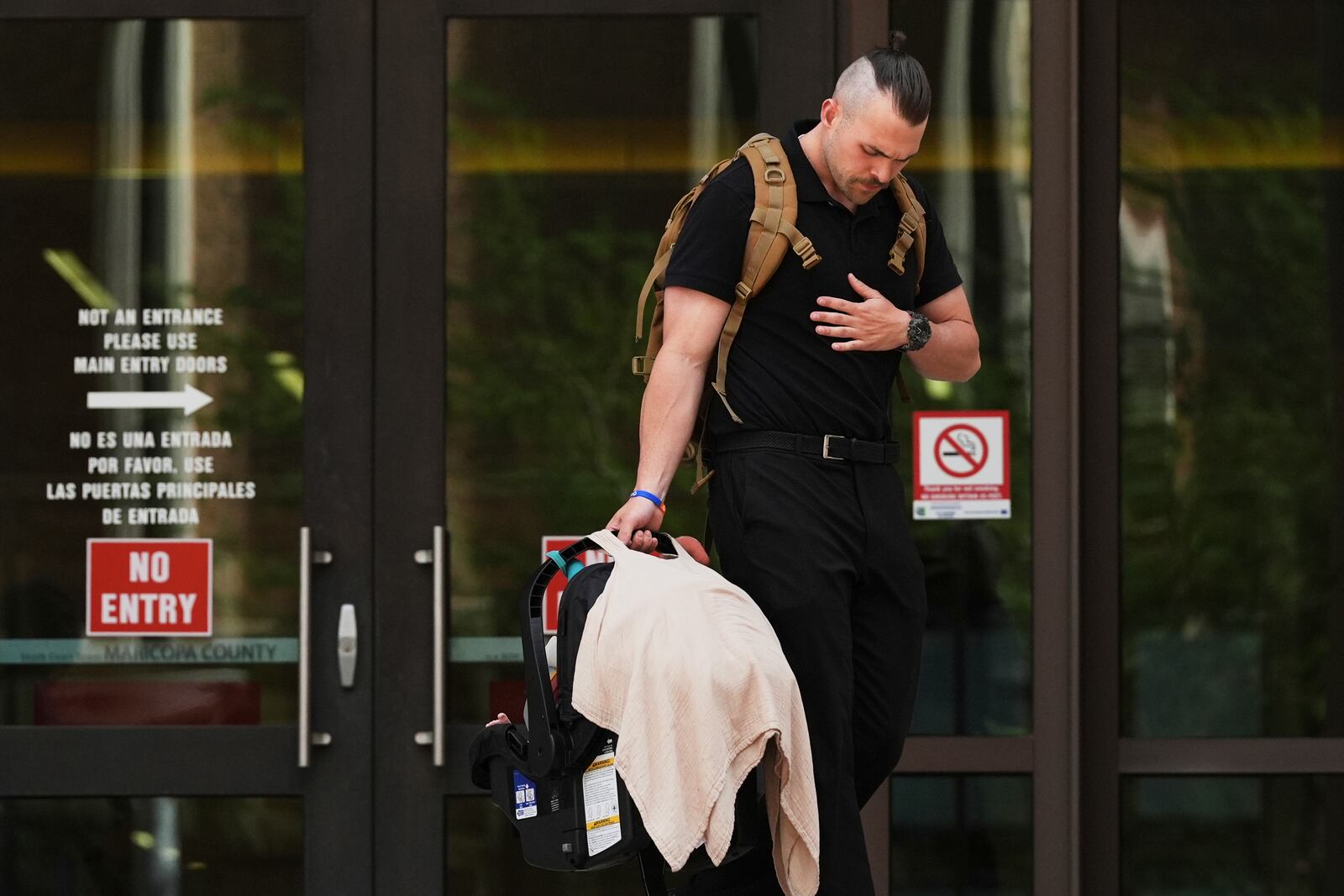 Colby Ryan leaves Maricopa County Superior Court for the murder trial of Lori Vallow Daybell, his mother, who is charged with conspiring to murder her estranged husband, Monday, April 21, 2025, in Phoenix. (AP Photo/Ross D. Franklin)