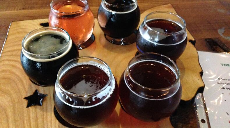 Half of the "12 Beer of Christmas" served up at the Dayton Beer Company's special event spotlighting Christmas ales and "winter warmers" on Dec. 13. MARK FISHER/STAFF