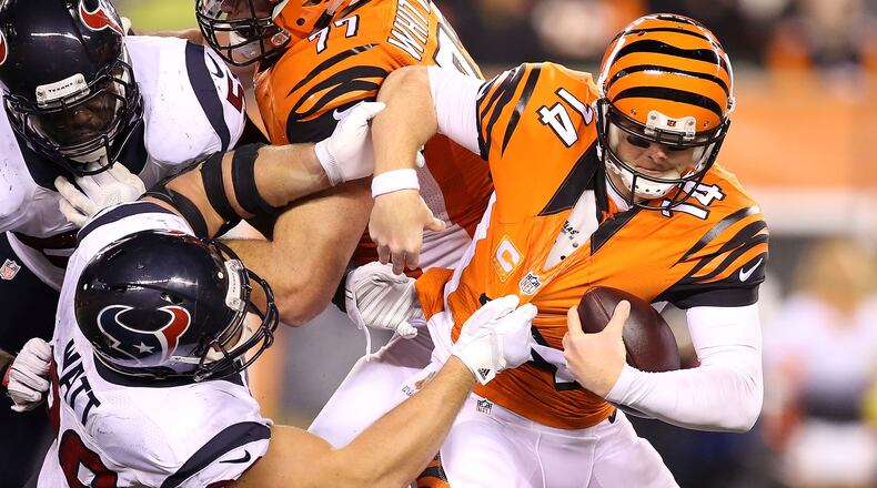 CINCINNATI, OH - NOVEMBER 16: J.J. Watt #99 of the Houston Texans sacks Andy Dalton #14 of the Cincinnati Bengals during the fourth quarter at Paul Brown Stadium on November 16, 2015 in Cincinnati, Ohio. Houston defeated Cincinnati 10-6. (Photo by Andy Lyons/Getty Images)
