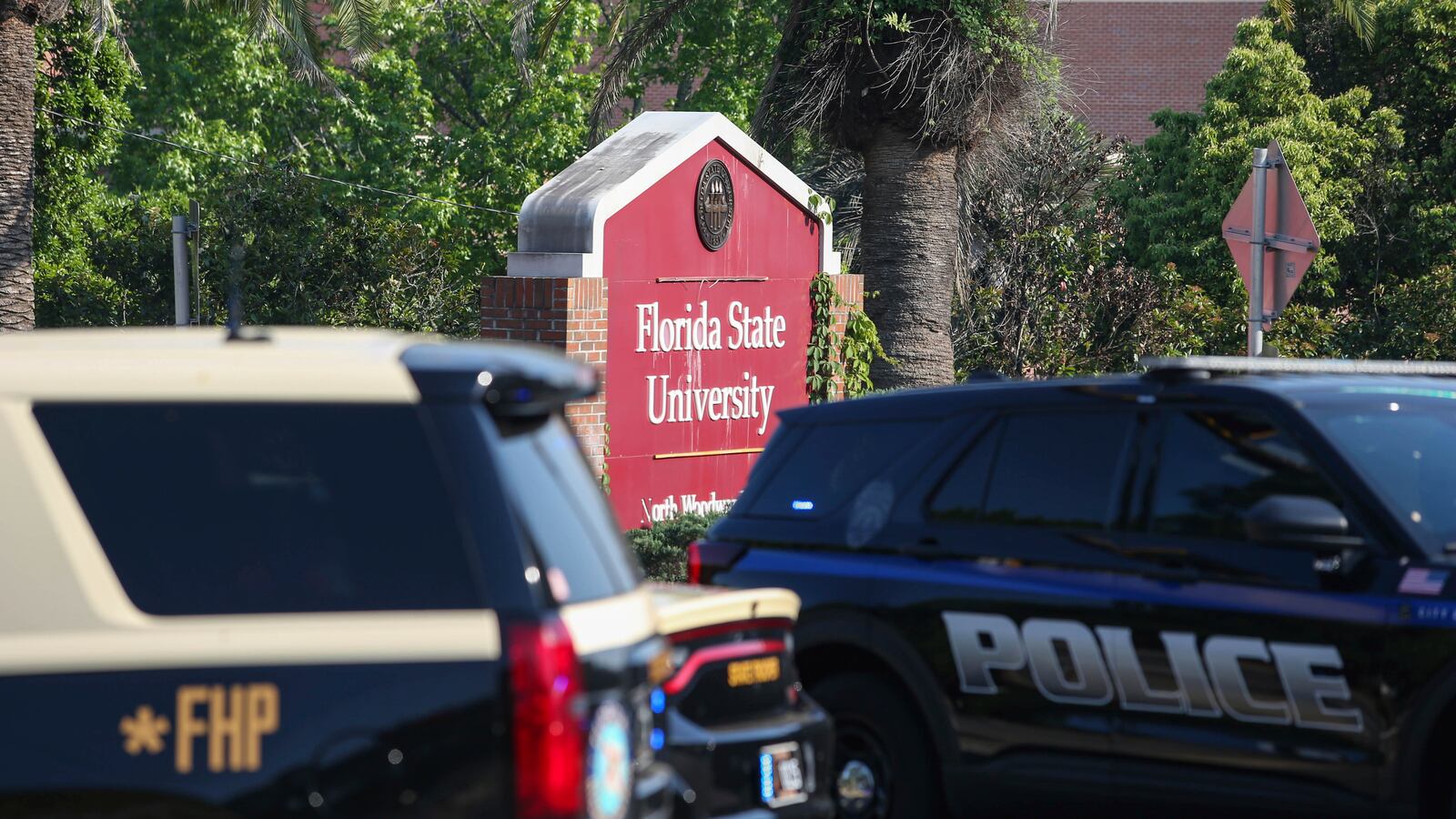 The Florida State Student Union building is seen behind law enforcement vehicles in Tallahassee, Fla., Thursday, April 17, 2025. (AP Photo/Gary McCullough)
