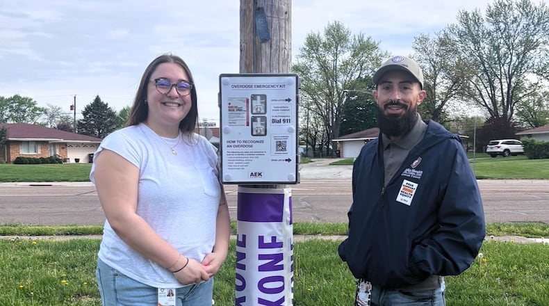 Kaci Warren and Colton Holley-Wolf from the Harm Reduction team at Greene County Public Health showcase the new outdoor NaloxBox in Fairborn. CONTRIBUTED