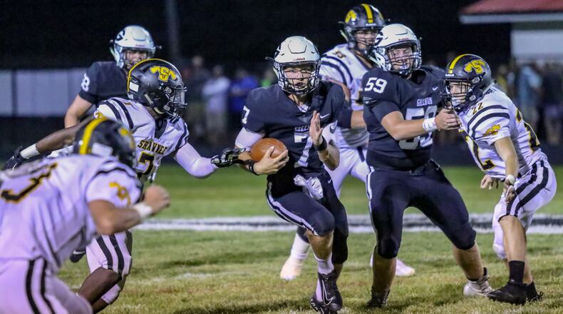 Greenon High School junior quarterback Cade Rice runs through the Shawnee defense during their game on Friday night at Greenon Stadium. The Knights won 56-39. CONTRIBUTED PHOTO BY MICHAEL COOPER