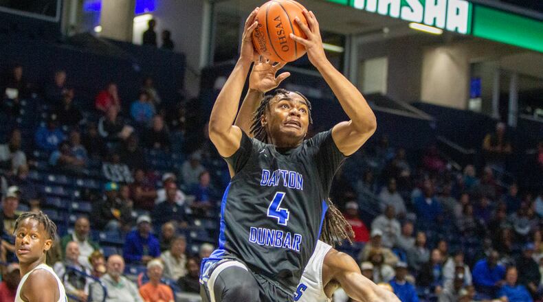 Dunbar's Antaune Allen drives to the basket during Sunday's Division II district final against Cincinnati Woodward at the Cintas Center. CONTRIBUTED/Jeff Gilbert