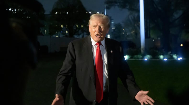 President Donald Trump talks with reporters upon his arrival at the White House in Washington, Sunday, Nov. 9, 2025. (AP Photo/Rod Lamkey, Jr.)