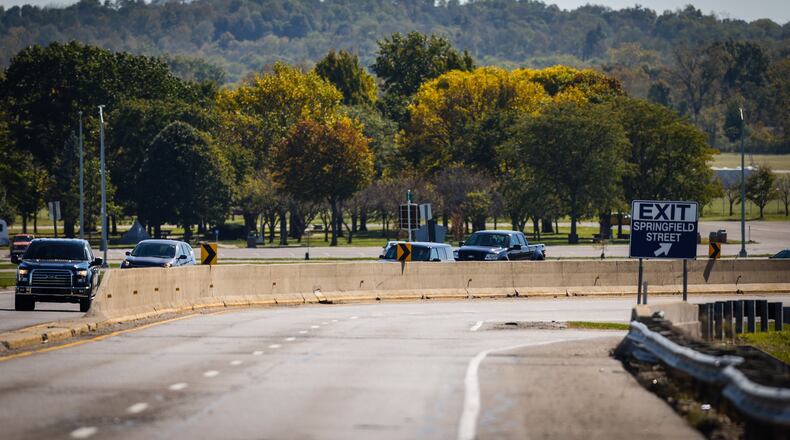Vehicles move along Harshman Rd. near the National Museum of the United States Air Force. Riverside service director Kathy Bartlett says the city plans to replace the road and the wall as the wall is at the end of its useful life. JIM NOELKER/STAFF