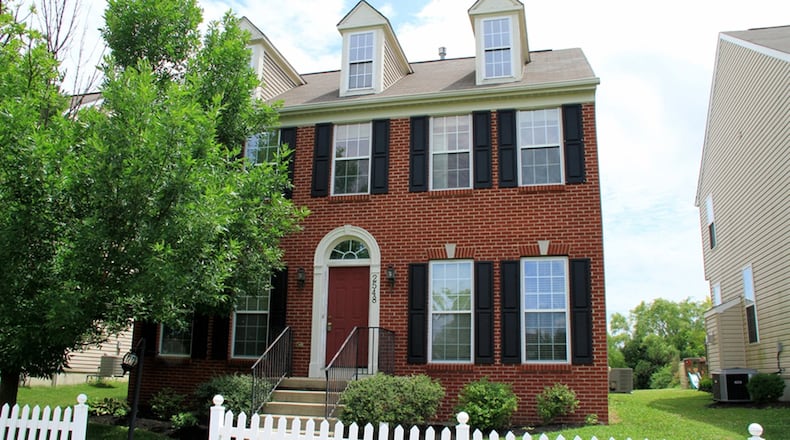This 2-story, brick-and-vinyl house with about 2,600 sq. ft. of living space and 3 bedrooms faces a city park and has an access road to the 2-car, attached garage. CONTRIBUTED PHOTOS BY KATHY TYLER