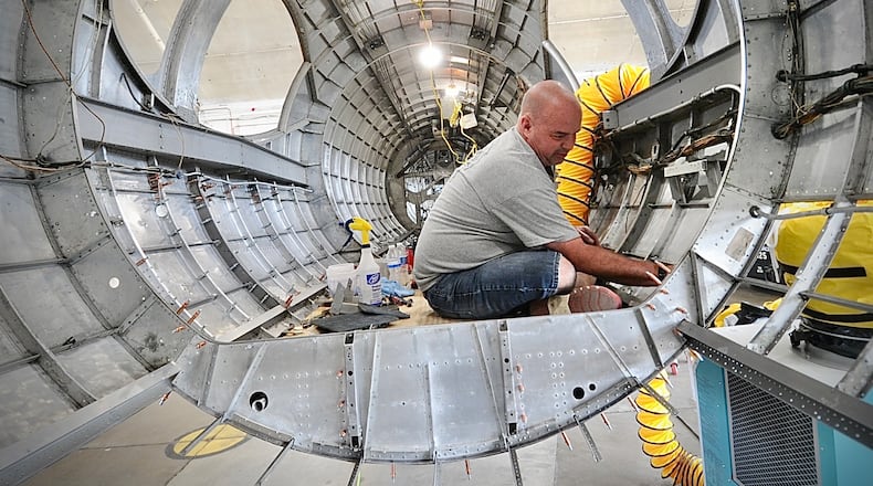 Duane Jones, a member of the restoration team for the National Museum of the U.S. Air Force Force, works inside the "Swoose," a Boeing B-17 D. The Swoose is the only existing Boeing B-17 D, museum curators say. MARSHALL GORBY \STAFF
