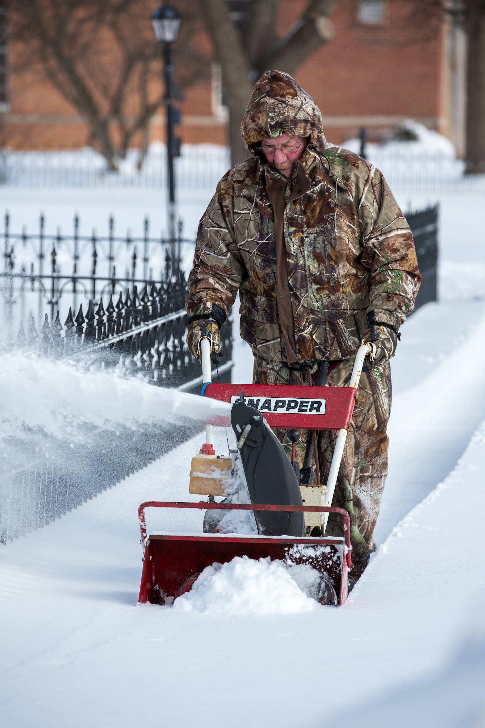 Alan McCabe using a snow blower to clear the sidewalks in front of St. Jacob's Lutheran Church along Central Avenue in Miamisburg on Tuesday, Jan. 27, following the late January snow storm. CONTRIBUTED