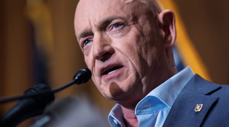 FILE - Sen. Mark Kelly, D-Ariz., refutes efforts by President Donald Trump and Defense Secretary Pete Hegseth to intimidate him and other lawmakers after expressing concerns over U.S. military strikes against vessels suspected of smuggling drugs in the Caribbean, during a news conference at the Capitol, in Washington, Dec. 1, 2025. (AP Photo/J. Scott Applewhite, File)