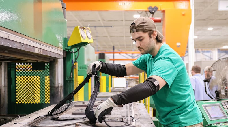A worker at WCR pulls a newly pressed gasket out of an oven at the company's Xenia factory. WCR Inc. has recently moved into its new corporate headquarters in Xenia. BRYANT BILLING/STAFF