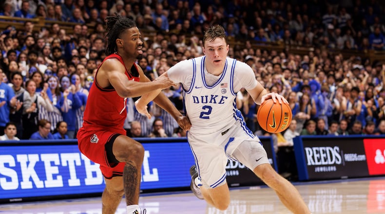 Duke's Cooper Flagg (2) drives past North Carolina State's Bryce Heard (7) during the second half of an NCAA college basketball game in Durham, N.C., Tuesday, Jan. 28, 2025. (AP Photo/Ben McKeown)