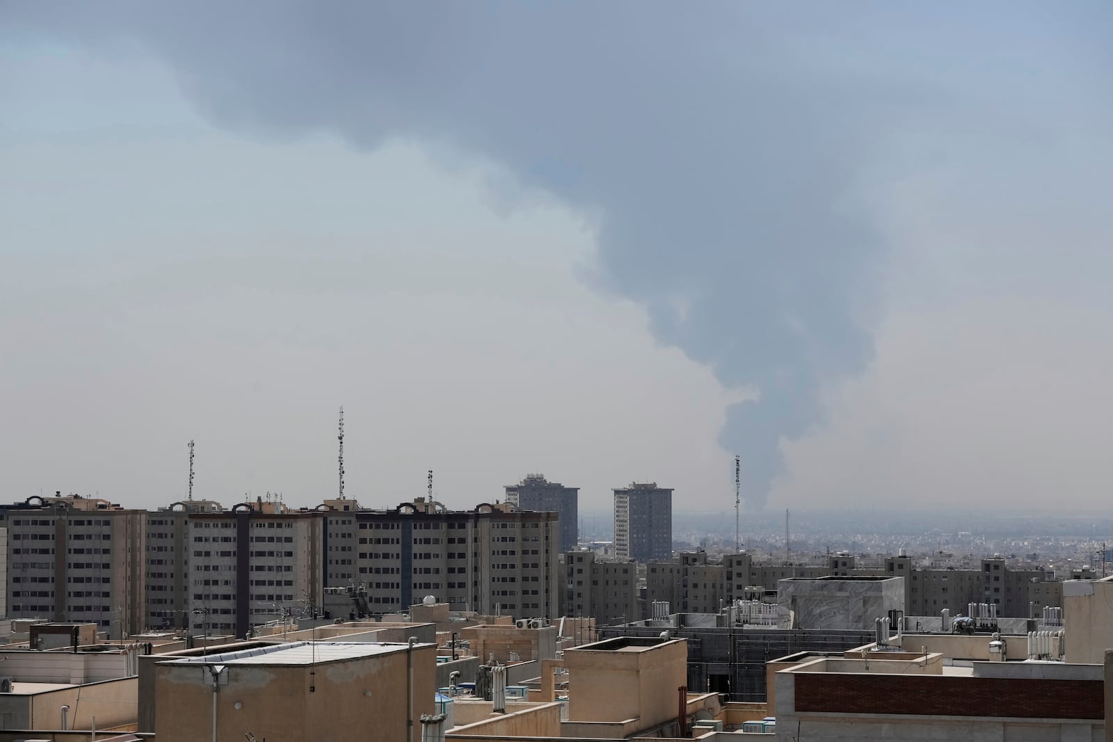Huge smoke rises up from an oil facility after a Saturday explosion in southern Tehran, Iran, Sunday, June 15, 2025. (AP Photo/Vahid Salemi)