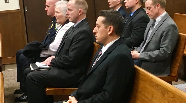 Former Kettering police detective Ryan Meno waits in court before he was sentenced for theft of drugs, theft in office and obstruction of justice after he admitted to stealing pain pills from an elderly woman’s home.