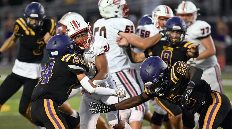 Bellbrook High School's Christian Burchfield (left) and Gage Cameron hit Tippecanoe High School's Xavier Melton  during their game on Friday, Aug. 22 at Miami Valley South Stadium. Tippecanoe won 21-0. NICK FALZERANO / CONTRIBUTED PHOTO