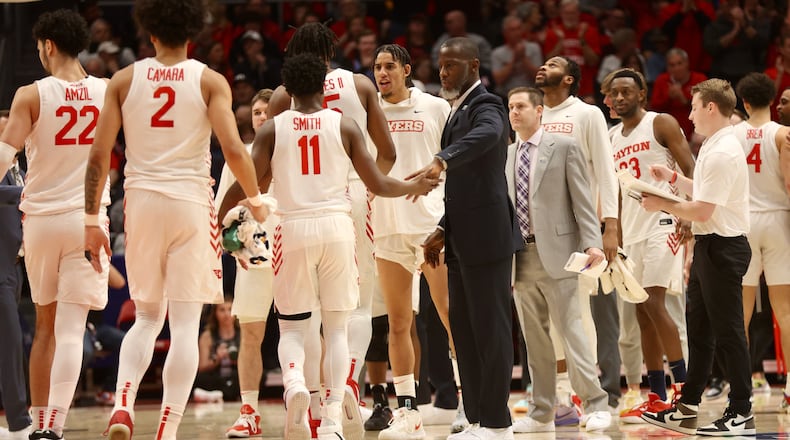 Dayton coach Anthony Grant greets players during a timeout against Richmond on Saturday, Jan. 28, 2023, at UD Arena. David Jablonski/Staff