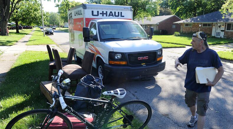 Daniel Sizemore moved his belongings to the curb after being evicted from his home in Kettering, Tuesday, June 15, 2021. MARSHALL GORBY\STAFF