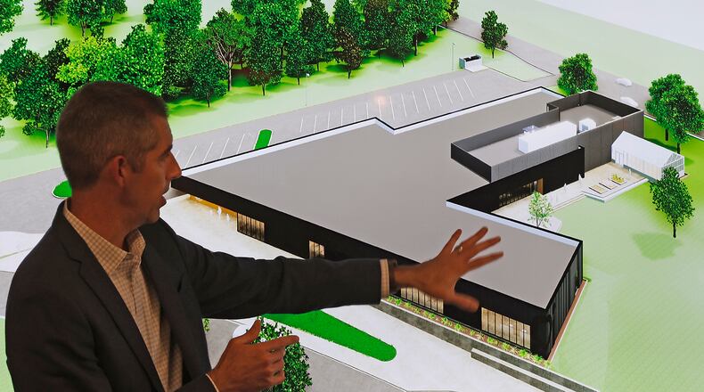 Architect Todd Boyer, from WSA Studio, talks about the new Global Impact STEM Academy building that his company designed on the Clark State College campus during a GISA board meeting Tuesday, Nov. 14, 2023. BILL LACKEY/STAFF