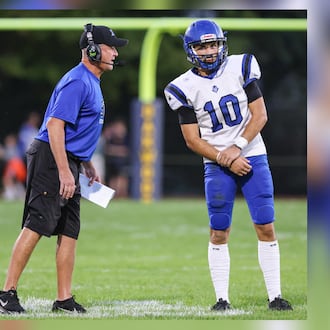 Brookville High School head coach Mike Hetrick gives a play call to junior Jayden Resor during their Southwestern Buckeye League game against Oakwood on Friday, Oct. 3, 2025 at Mack Hummon Stadium. BRYANT BILLING / STAFF