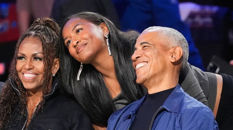 From left, Michelle Obama, Sasha Obama and Barack Obama pose for a photo before the NBA All-Star basketball game Sunday, Feb. 15, 2026, in Inglewood, Calif. (AP Photo/Mark J. Terrill)