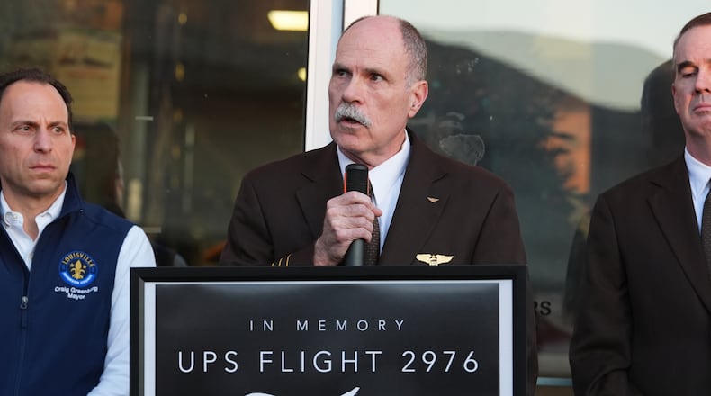 Independent Pilots Association President Bob Travis, center, speaks during a vigil Thursday, Nov. 6, 2025, in Louisville, Ky., after a UPS plane crashed at Louisville Muhammad Ali International Airport. (AP Photo/Darron Cummings)