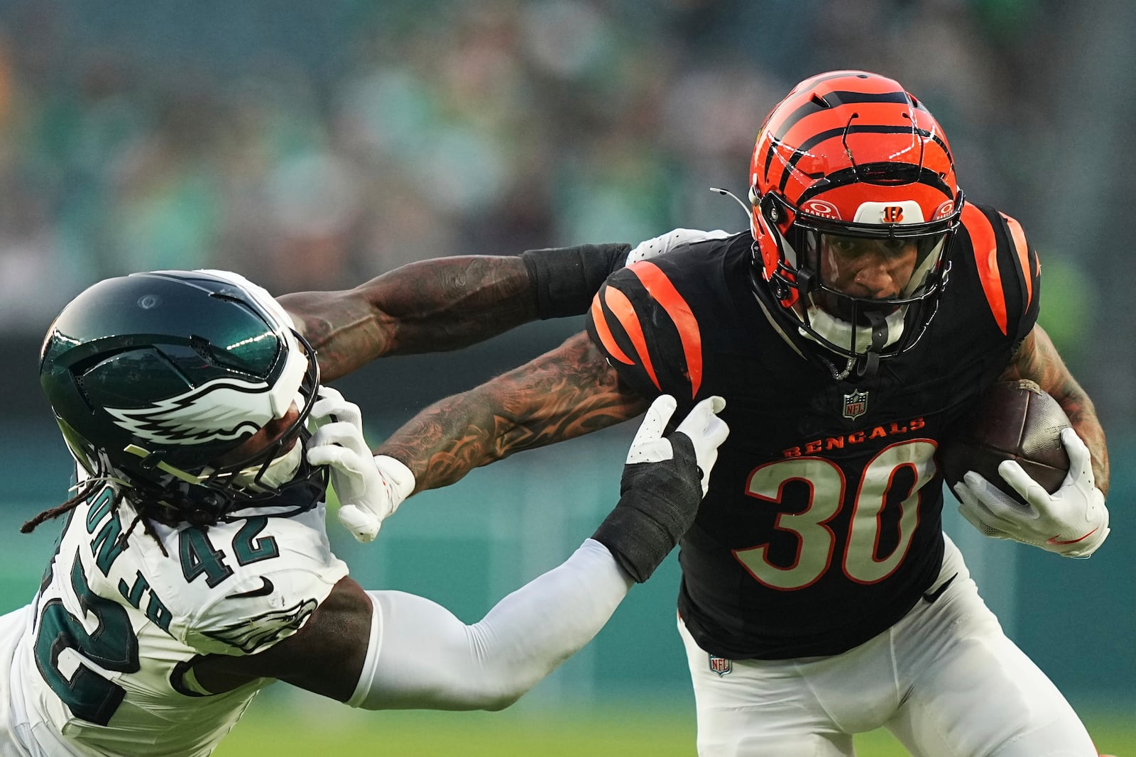 Philadelphia Eagles linebacker Smael Mondon Jr. (42) tries to stop Cincinnati Bengals running back Chase Brown (30) during the first half of an NFL preseason football game Thursday, Aug. 7, 2025, in Philadelphia. (AP Photo/Matt Rourke)