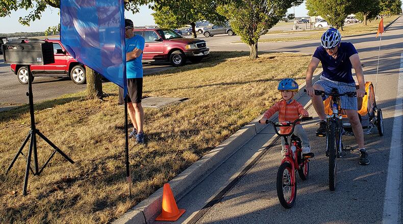 Maj. Will Jones of the Air Force Materiel Command Law Office with his son James, who is 4, get ready to cycle at the starting line of the Blue Streak Time Trial. The Oct. 13 was the final ride of the 2019 season. (Contributed photo/Chuck Smith)