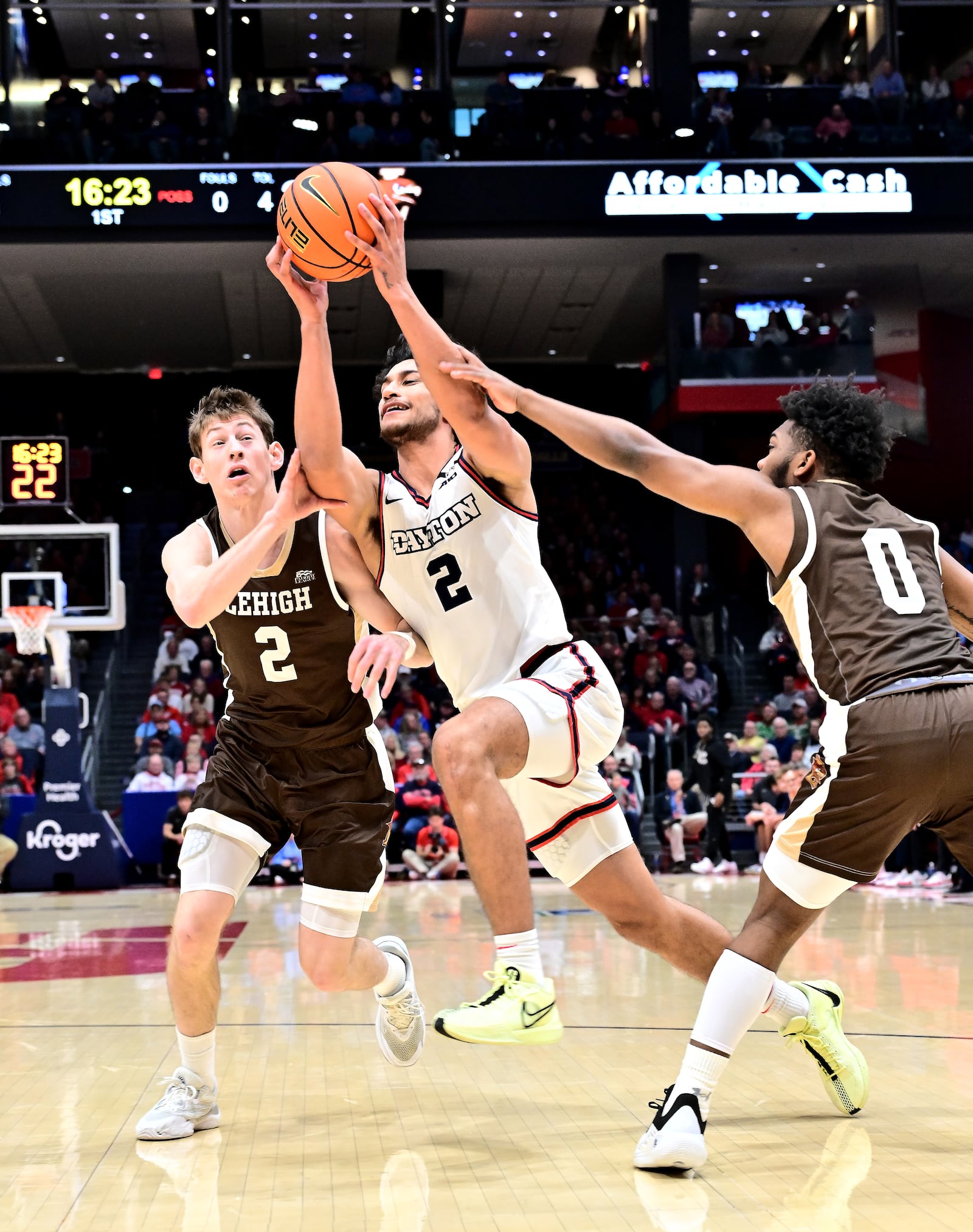 Dayton's Nate Santos splits Lehigh defenders Ben Knostman (2) and Cam Gillus during Saturday's game at UD Arena. Erik Schelkun/UD Athletics photo
