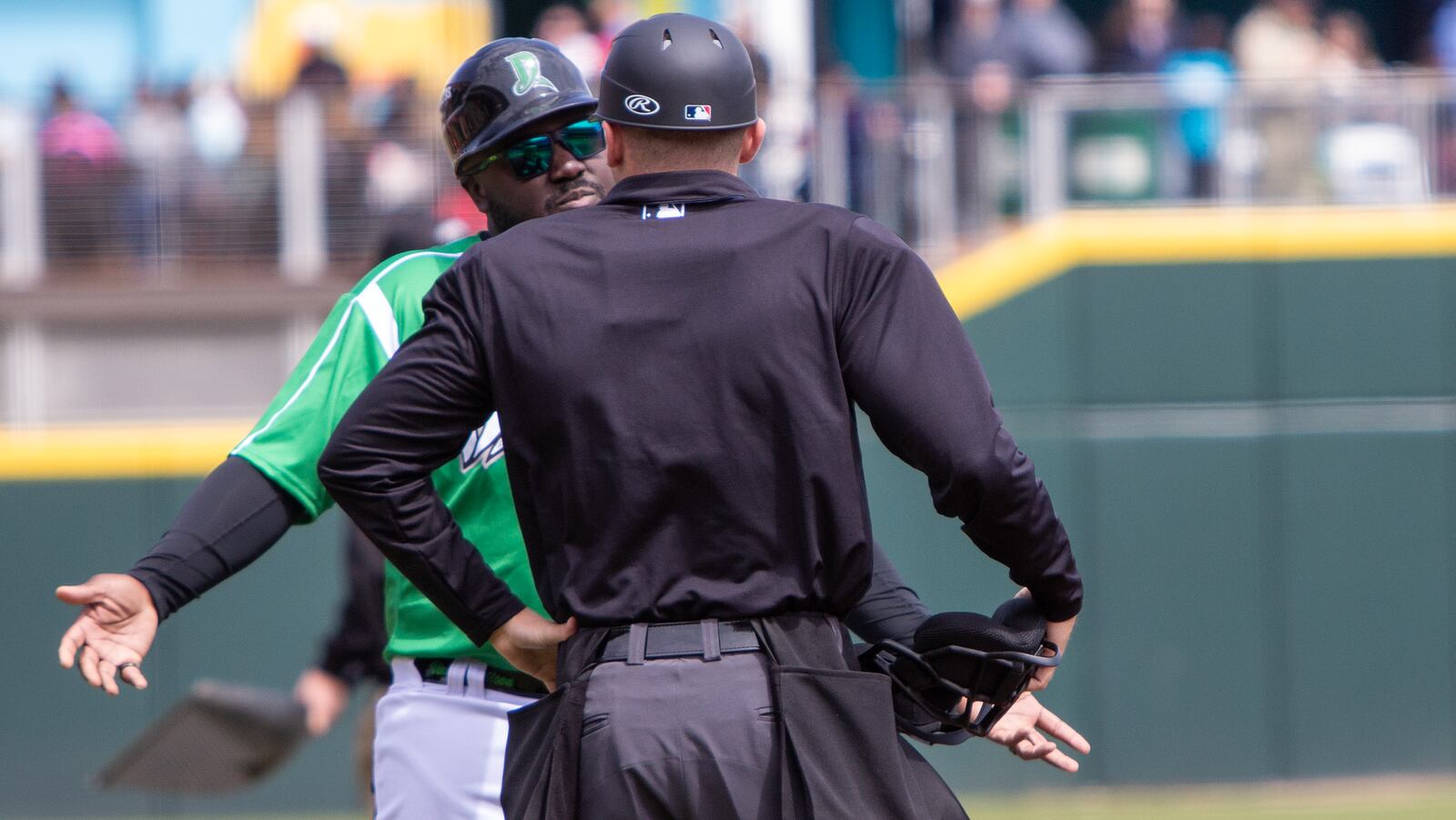 Dragons manager Vince Harrison Jr. argues with umpire Brandon Spevak about a call at first base during Sunday's game at Day Air Ballpark. Jeff Gilbert/CONTRIBUTED