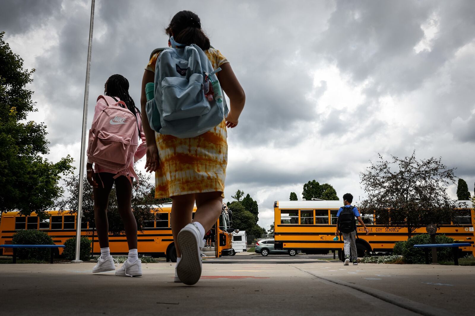 Children at Cline Elementary School in Centerville load into buses after the first day of school Wednesday August 18, 2021. All of the kids were wearing masks. JIM NOELKER/STAFF