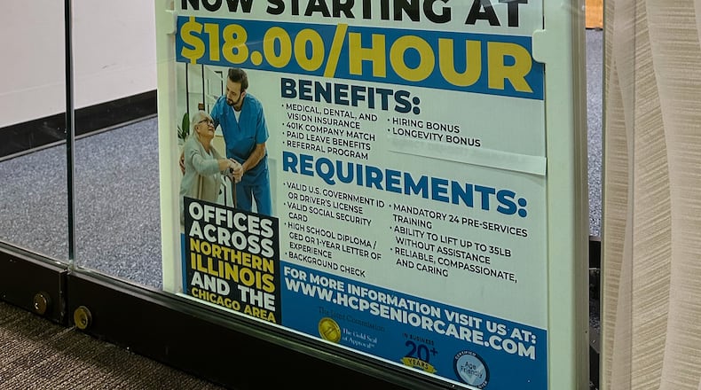 Hiring sign is displayed at a office in Schaumburg, Ill., Tuesday, Jan. 5, 2026. (AP Photo/Nam Y. Huh)