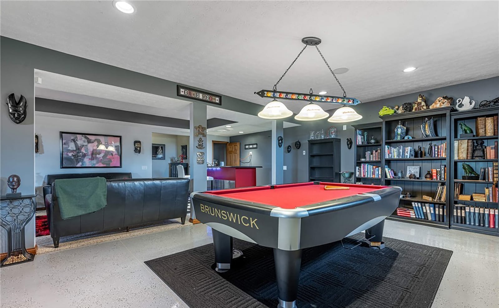 The finished basement has a game area with a pool table that conveys, a theater area and wet bar with full size refrigerator. CONTRIBUTED