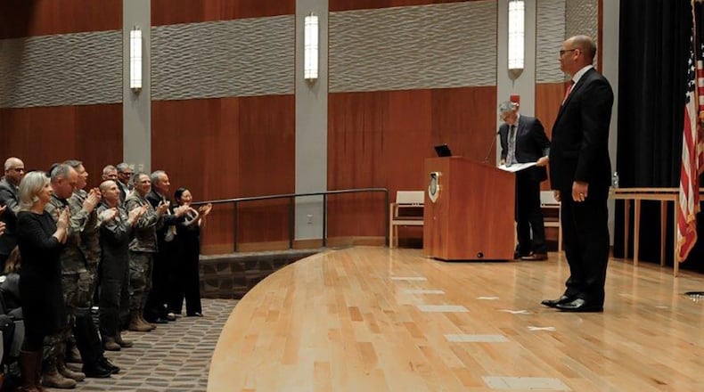 Duane Harrison, National Air and Space Intelligence Center’s newly inducted chief scientist, stands as a crowd gives him a standing ovation during the chief scientist induction ceremony Oct. 25. Harrison has worked at NASIC for over 18 years and became the eighth chief scientist in NASIC’s history. (U.S. Air Force photo/Senior Airman Samuel Earick)
