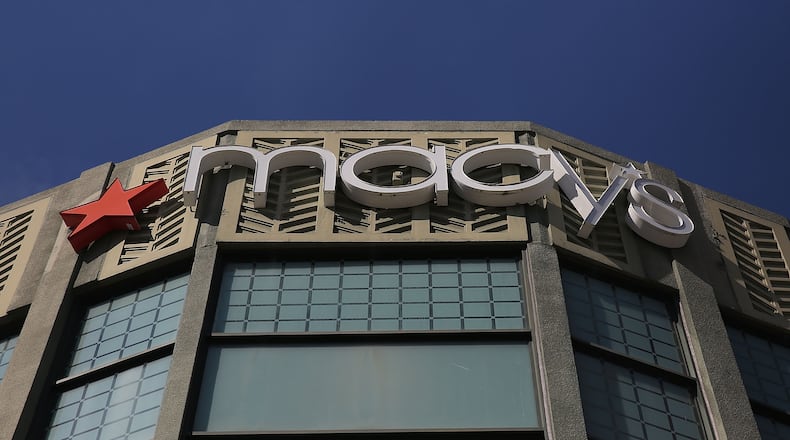 A Macy’s sign is seen on a store at CityPlace in West Palm Beach, Fla., which is one of 68 stores that the company plans on closing on Jan. 5, 2017. Cincinnati-based Macy’s announced more job cuts than any other company last month when it said it was planning to shut down the stores and reduce payroll by more than 10,000. (Photo by Joe Raedle/Getty Images)