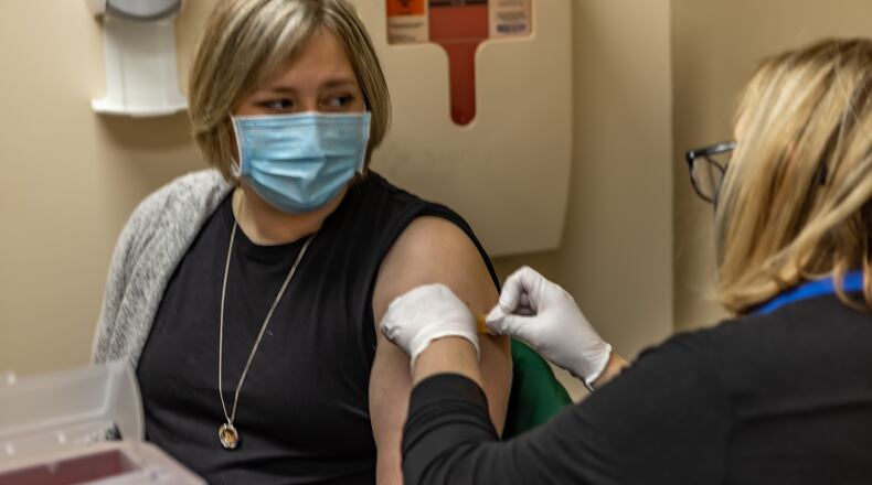 Dr. Andrea Dillon receives her first shot of a two-dose coronavirus vaccine regimen at Miami Valley Hospital North. Photo provided by Premier Health.