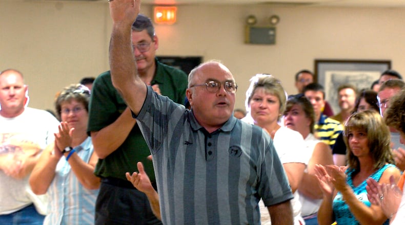 Former Northeastern head football coach Jerry Wasserman acknowledges the standing ovation he receives at the conclusion of a reception in his honor for all his years of coaching.  Staff photo by Bill Lackey