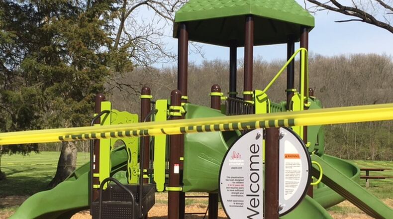 Caution tape was put up around playground equipment at Layer Park in Miami Twp., where work continues to be done after the U.S. Environmental Protection Agency removed about 60 tons of soil due to lead contamination that closed the park in early 2016. NICK BLIZZARD/STAFF