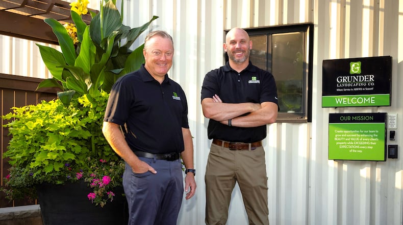Grunder Landscaping Co. founder and CEO Marty Grunder and company President and Chief Operating Officer Seth Pflum stand outside Grunder Landscaping at 1900 Byers Road in Miamisburg. Founded in 1984, the business recently launched renovations on a Loveland facility ahead of a planned November opening. CONTRIBUTED