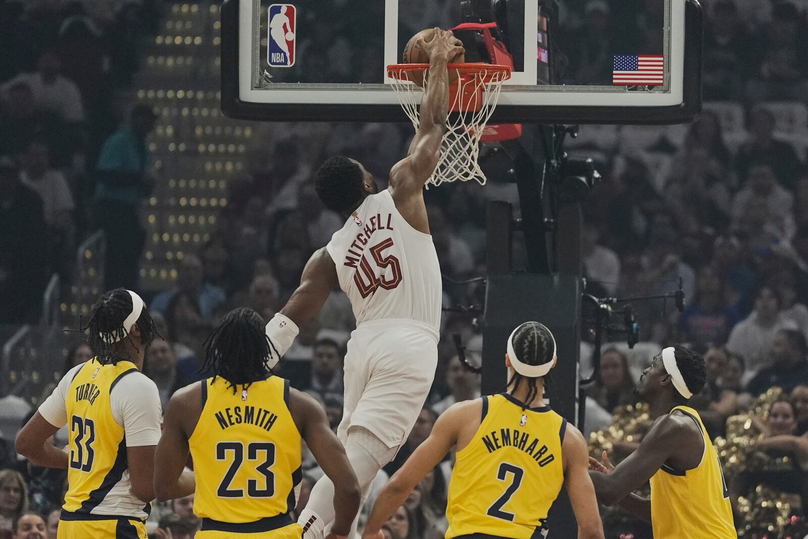 Cleveland Cavaliers guard Donovan Mitchell (45) dunks in front of Indiana Pacers center Myles Turner (33), forward Aaron Nesmith (23), guard Andrew Nembhard (2) and forward Pascal Siakam, right, in the first half during Game 2 in the Eastern Conference semifinals of the NBA basketball playoffs Tuesday, May 6, 2025, in Cleveland. (AP Photo/Sue Ogrocki)