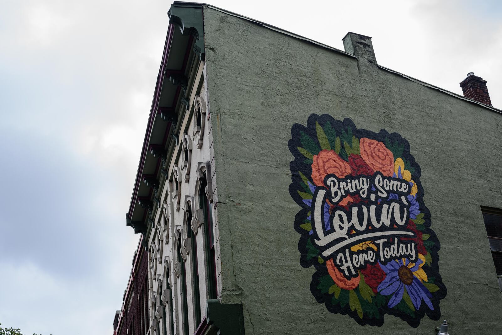 Artists Atalie Gagnet and Tiffany Clark painted the "Bring Some Lovin' Here Today" mural outside of Blind Bob's in the Oregon District. The mural was inspired by John Legend’s cover of Marvin Gaye’s “What’s Going On?” at Blind Bob’s in a special private performance. The singer visited the historic neighborhood a week after the mass shooting. TOM GILLIAM/CONTRIBUTED