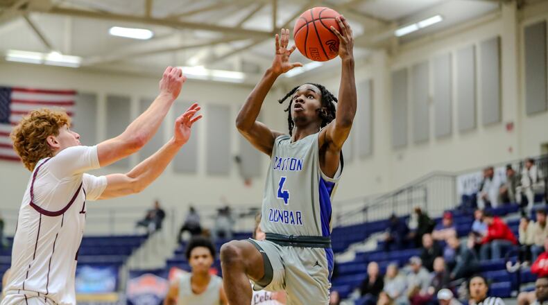 Dunbar High School sophomore Kevin Jackson drives to the hoop against Lebanon junior Luke Faler during their game at The Beacon Orthopaedics Flyin' to the Hoop Invitational on Saturday morning at Kettering's Trent Arena. MICHAEL COOPER/CONTRIBUTED