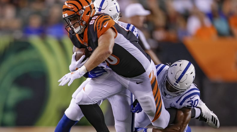 CINCINNATI, OH - AUGUST 30: Mason Schreck #86 of the Cincinnati Bengals runs the ball and is tackled from behind by George Odum #30 of the Indianapolis Colts during a preseason game at Paul Brown Stadium on August 30, 2018 in Cincinnati, Ohio. (Photo by Michael Hickey/Getty Images)