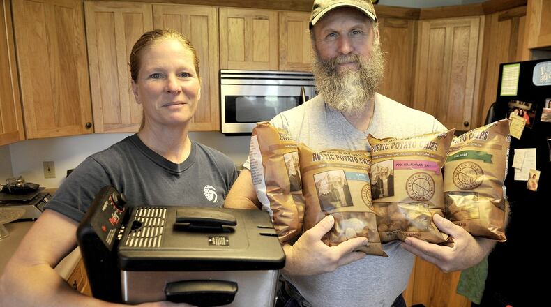 Jeanne Rue holds the small fryer she and her husband, Matt, started making their potato chips with. Two years later, they are selling Rue Farms Rustic Patoto Chips at Whole Foods and several other area grocery stores. Bill Lackey/Staff
