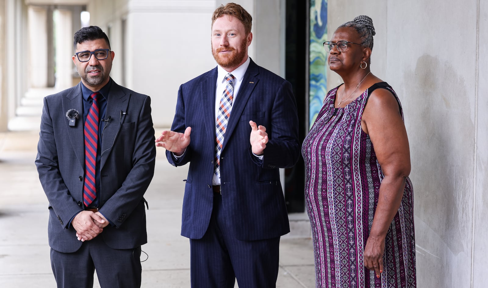 Dayton Municipal Court Clerk of Courts Marty Gehres (center) speaks during a news conference on Tuesday, June 17 outside the Montgomery County Courthouse. Montgomery County Democratic Party Chairperson Mohamed Al-Hamdani (left) also spoke at the news conference, and Montgomery County Democratic Party Executive Director Beverly King (right) was in attendance. BRYANT BILLING / STAFF
