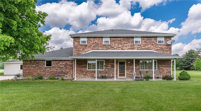 The front of the brick two-story home has a full covered front porch and a two-car attached, side-entry garage. CONTRIBUTED PHOTOS