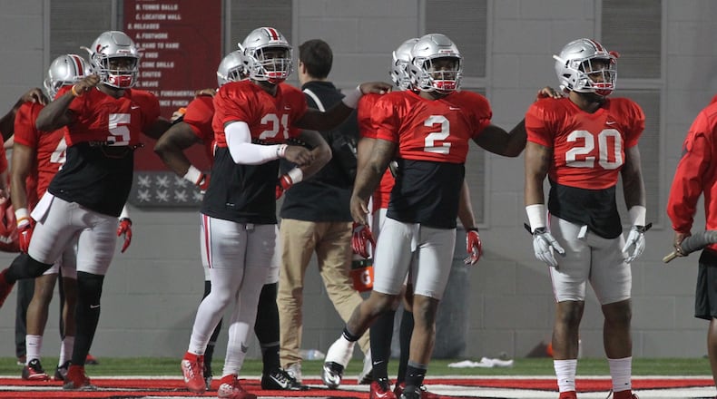 Ohio State players (left to right) Johnnie Dixon, Parris Campbell, Dontre Wilson and Mike Weber stretch before spring football practice on Tuesday, March 29, 2016, at the Woody Hayes Athletic Center in Columbus. David Jablonski/Staff
