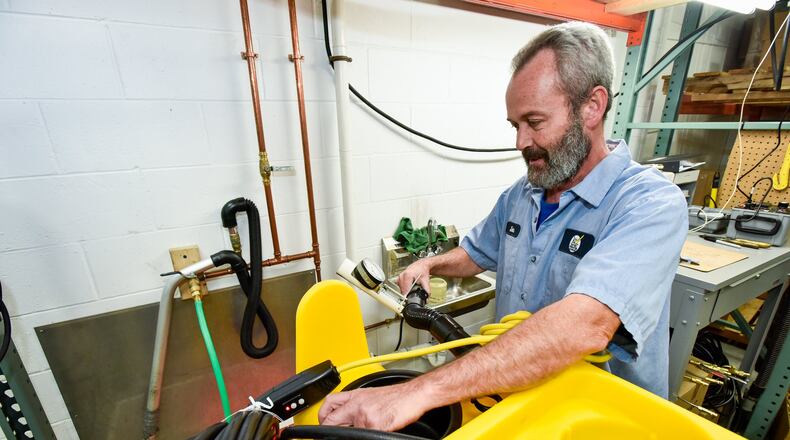 John Russell tests a cleaning machine at Kaivac Cleaning Systems in their facility on Van Hook Avenue Tuesday, Oct. 17 in Hamilton. The company makes cleaning equipment for commercial restrooms, kitchens and more and recently moved to this facility from another location in Hamilton. NICK GRAHAM/STAFF